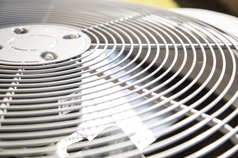 How Does an Air Conditioner Work? Top view of an air conditioner unit outdoors in hot summer season. No people.