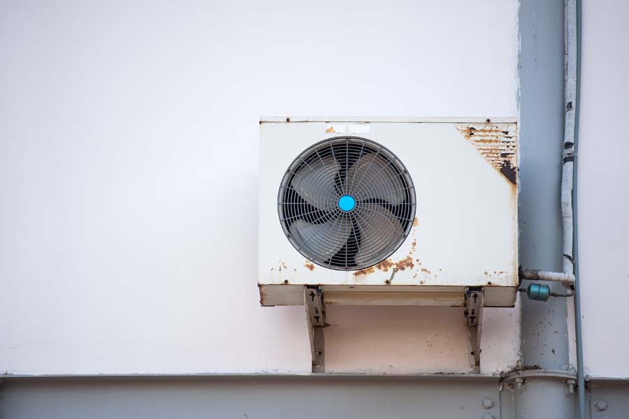 Air Conditioning Equipment outside of an old house. 3 Telltale Signs It’s Time for a New AC.