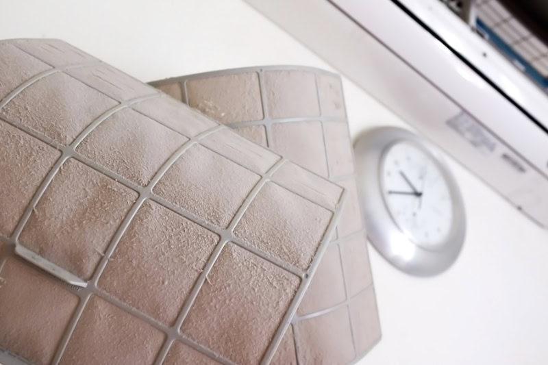 dirty filters in front of a clock.