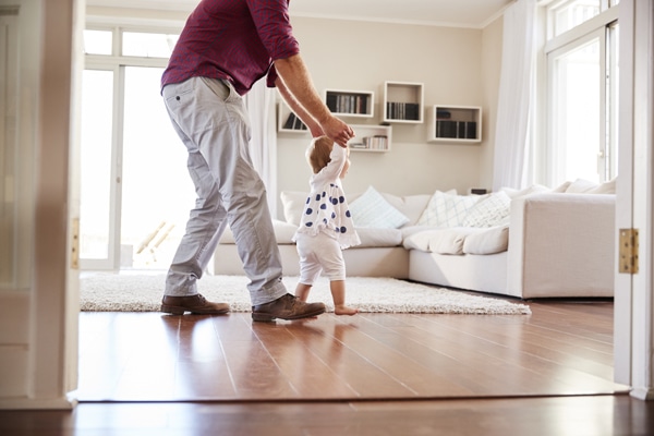 Father helping daughter learn to walk at home, side view. What Indoor Air Quality Accessories Can Help Keep Me Healthy?